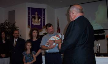Charley performing baby dedication